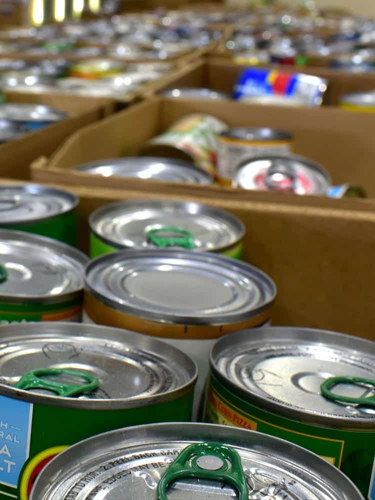 An array of canned food items, neatly packed and ready for distribution, representing the generous food donations at Hawaii Foodbank's warehouse.