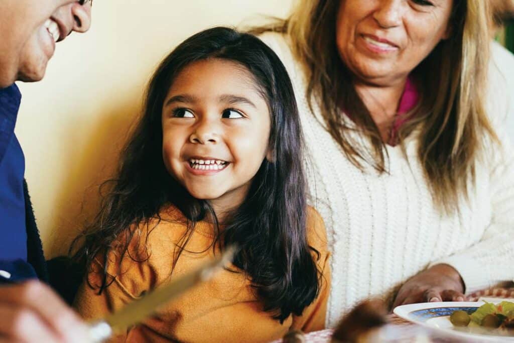 A child smiles during a holiday meal.